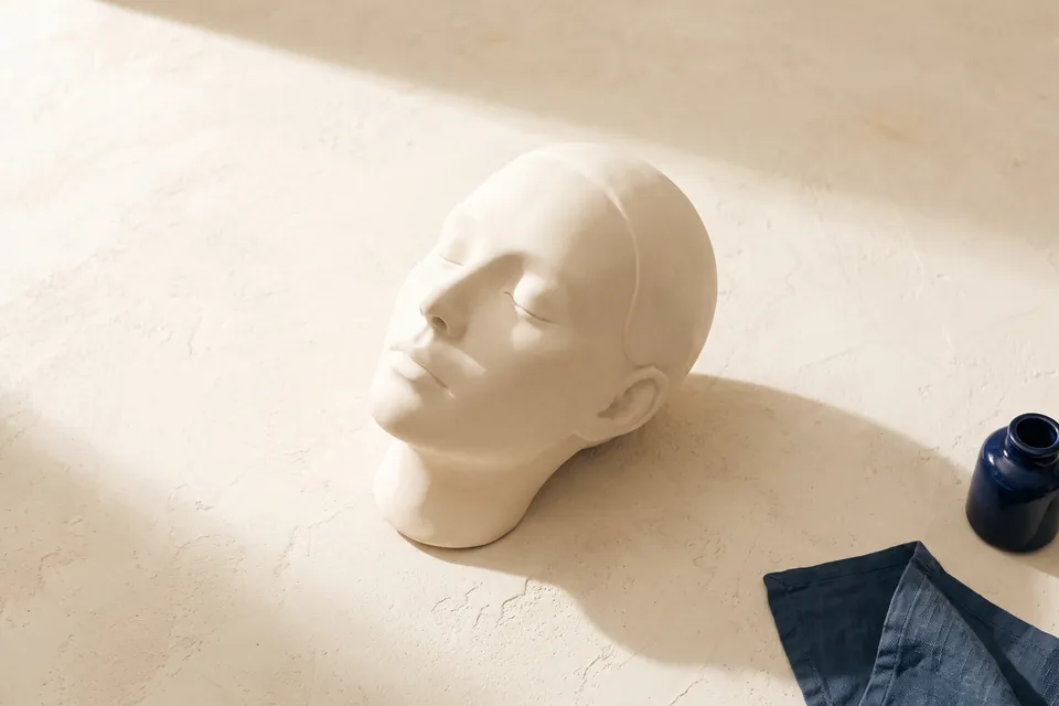 Gipsskulptur eines ruhigen Gesichts im Profil mit sanft geschlossenen Augen und glatter Stirn